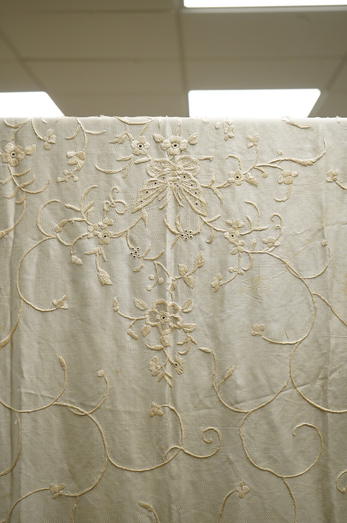 An early 20th century Chinese cream on cream silk embroidered, fringed stole, 65cm wide. Condition - some light staining.